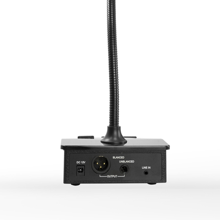 A microphone mounted on a stand, with its cable clearly visible, indicating that it is ready for recording or broadcasting activities.